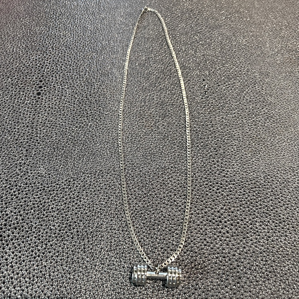 Silver dumbbell chain necklace.